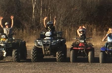 Four ATV riders lined up